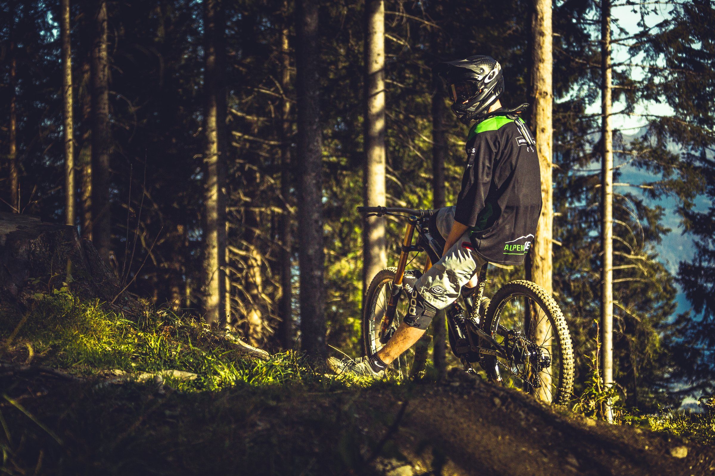 Rider auf dem Bike im dunklen Wald am Brambrüesch